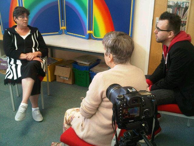 A video interview taking place in a community centre.